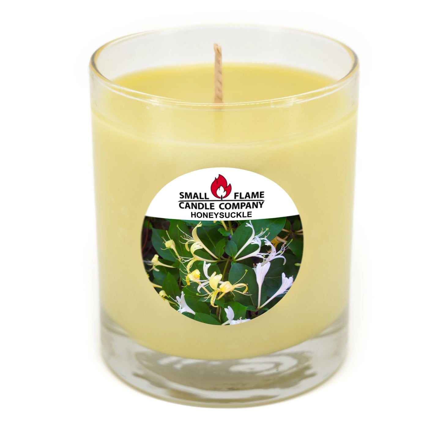 Hand-poured honeysuckle candle in clear glass jar with floral label, eco-friendly wax