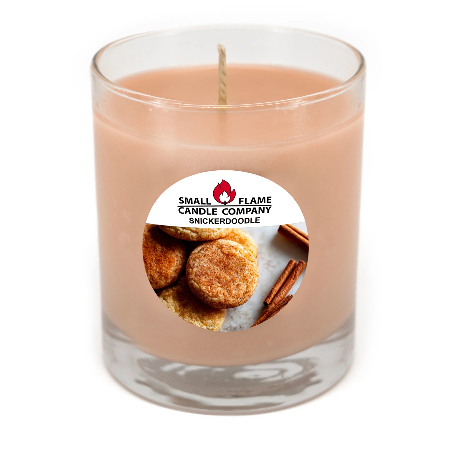 Snickerdoodle scented candle in clear glass jar with cookies and cinnamon stick label.