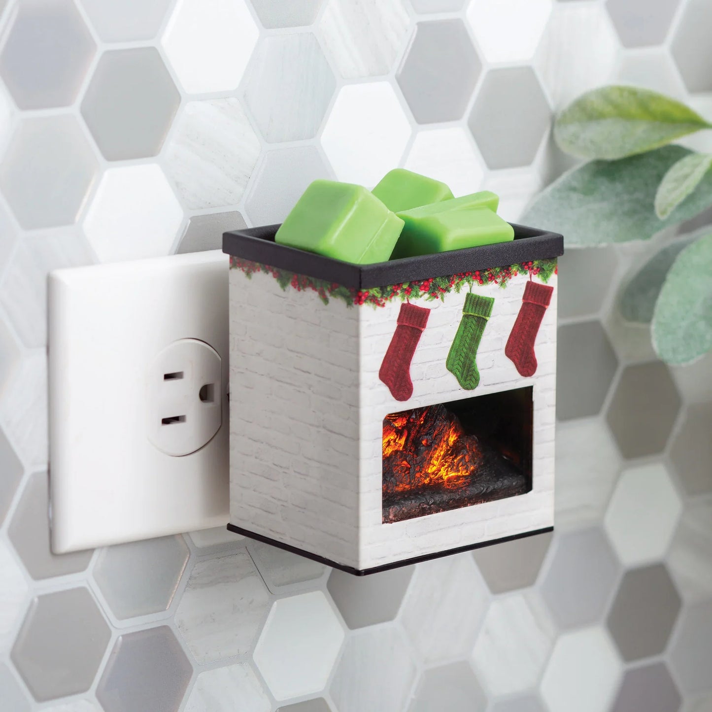 Plug-in fireplace wax melt warmer with green wax cubes and holiday stocking decorations