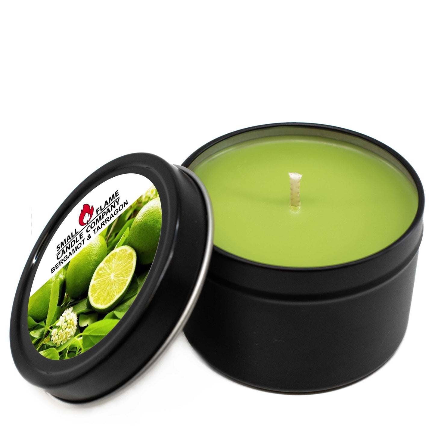 A green, hand-poured Bergamot and Tarragon Candle in a black tin with the lid off sits beside its lid, which features images of bergamot fruit and leaves plus scent details. Made from natural coconut soy wax.