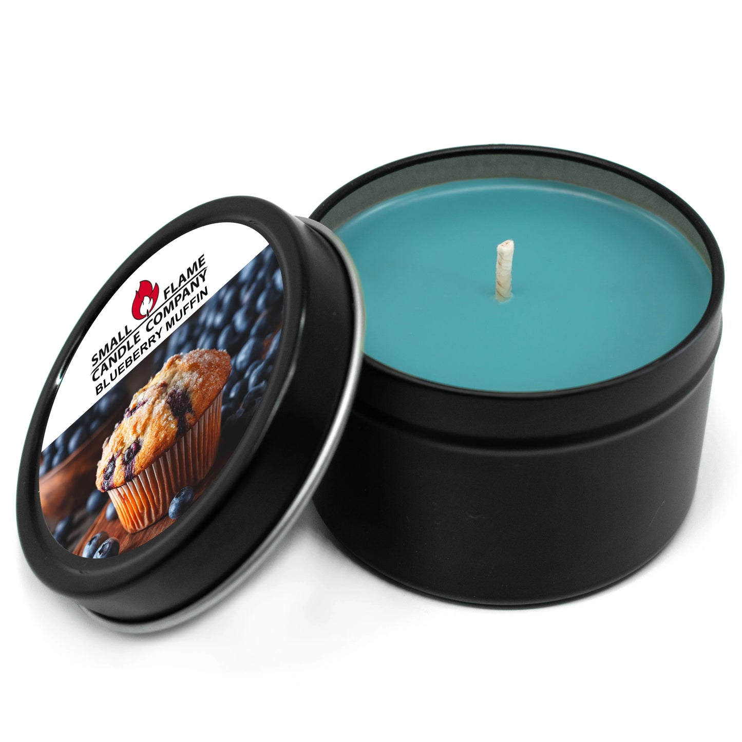 A round black tin holds a blue coconut soy wax candle from Blueberry Muffin Candles and Melts. The open lid shows a blueberry muffin image with the label "Small Flame Candle Company Blueberry Muffin," scented with natural oils.