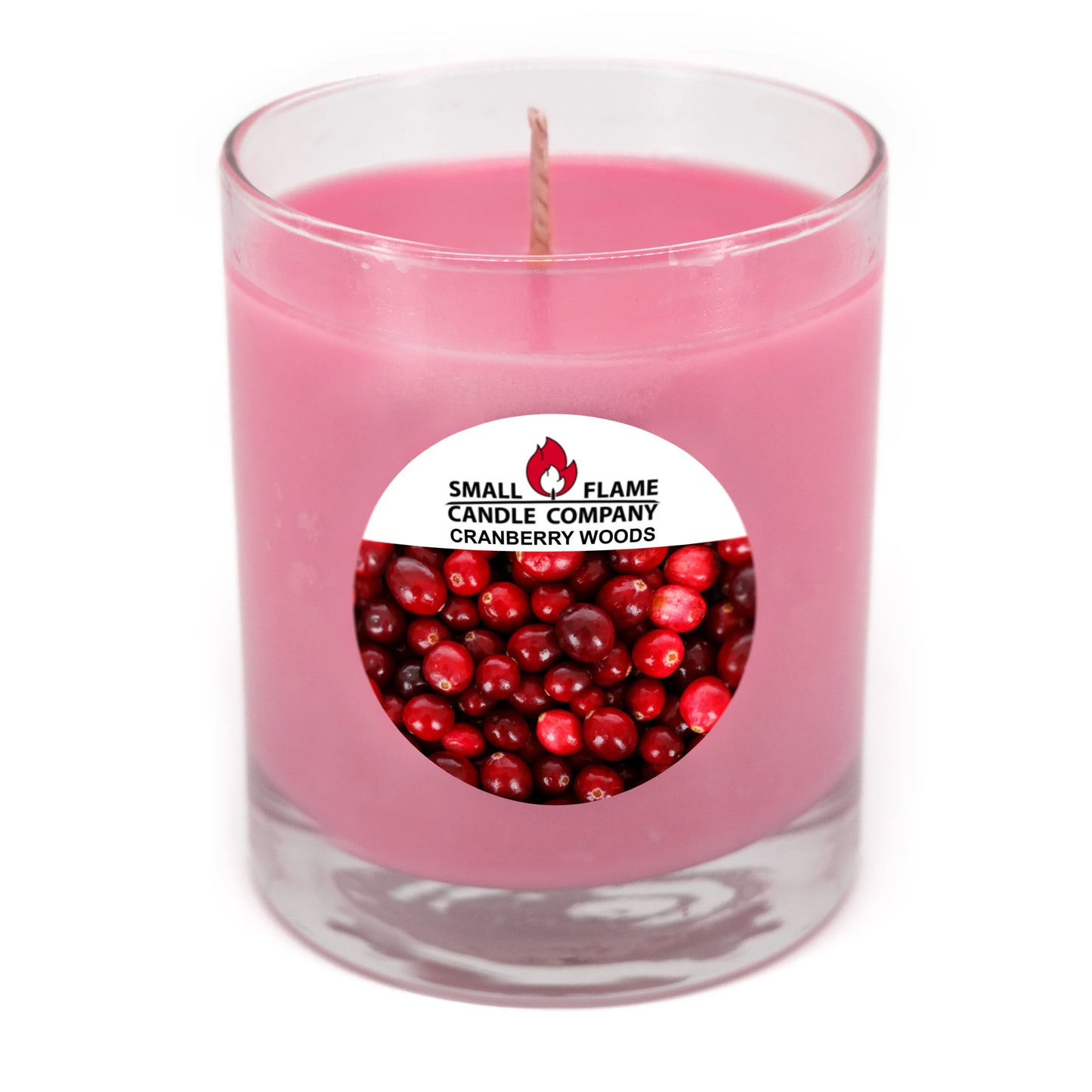 Pink Cranberry Woods scented candle in a clear glass jar with cranberries label.