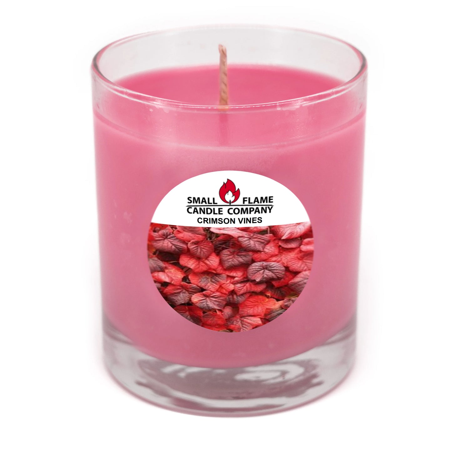 Pink coconut-soy candle in glass jar labeled Crimson Vines with red foliage design