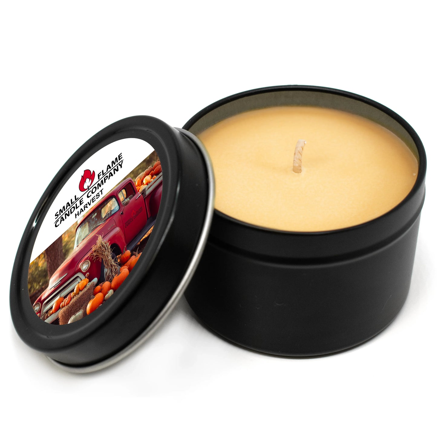 Hand-poured coconut-soy candle in black tin with harvest-themed label and vintage truck image