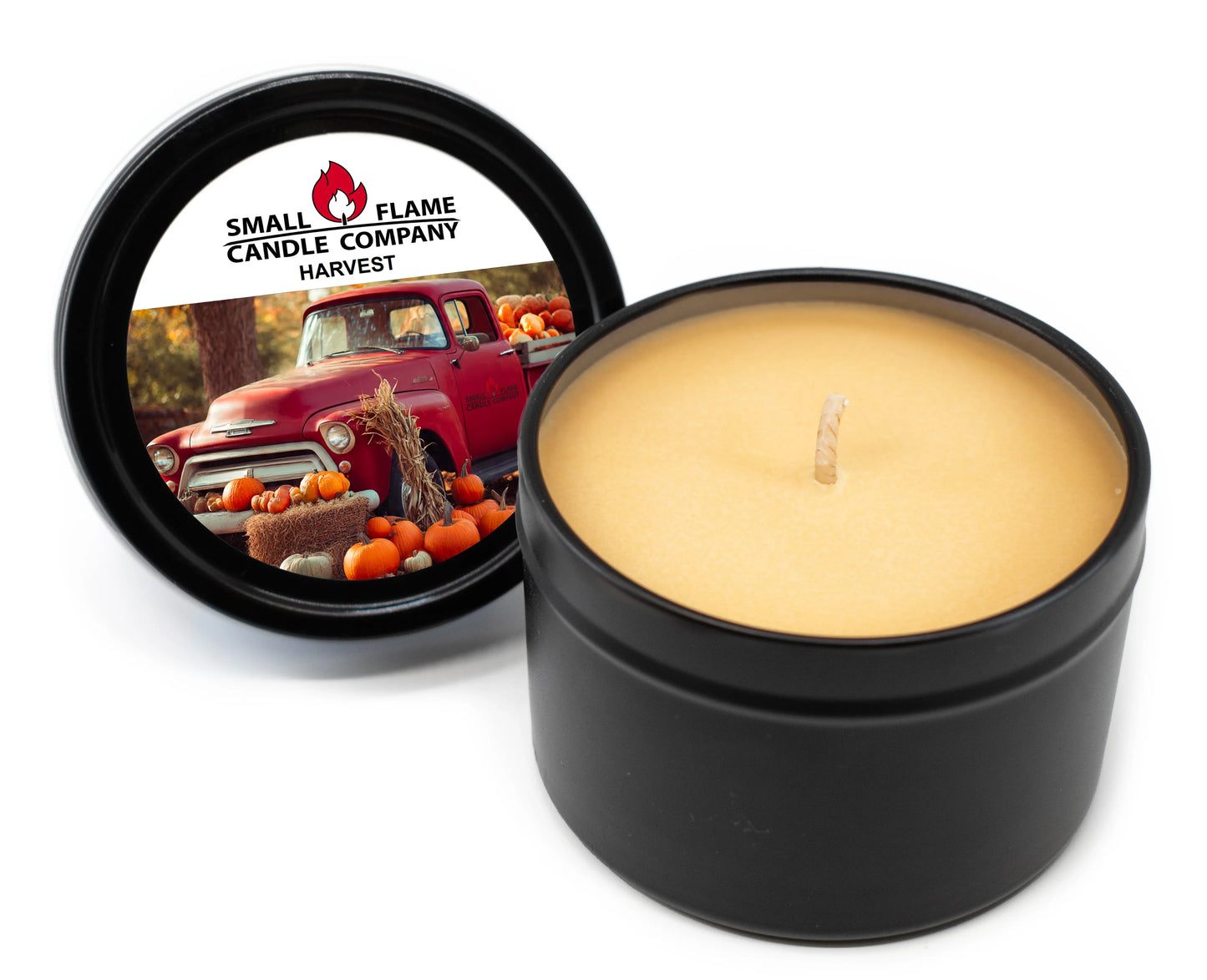 Harvest-scented coconut-soy candle in black tin with fall pumpkin and vintage truck label.