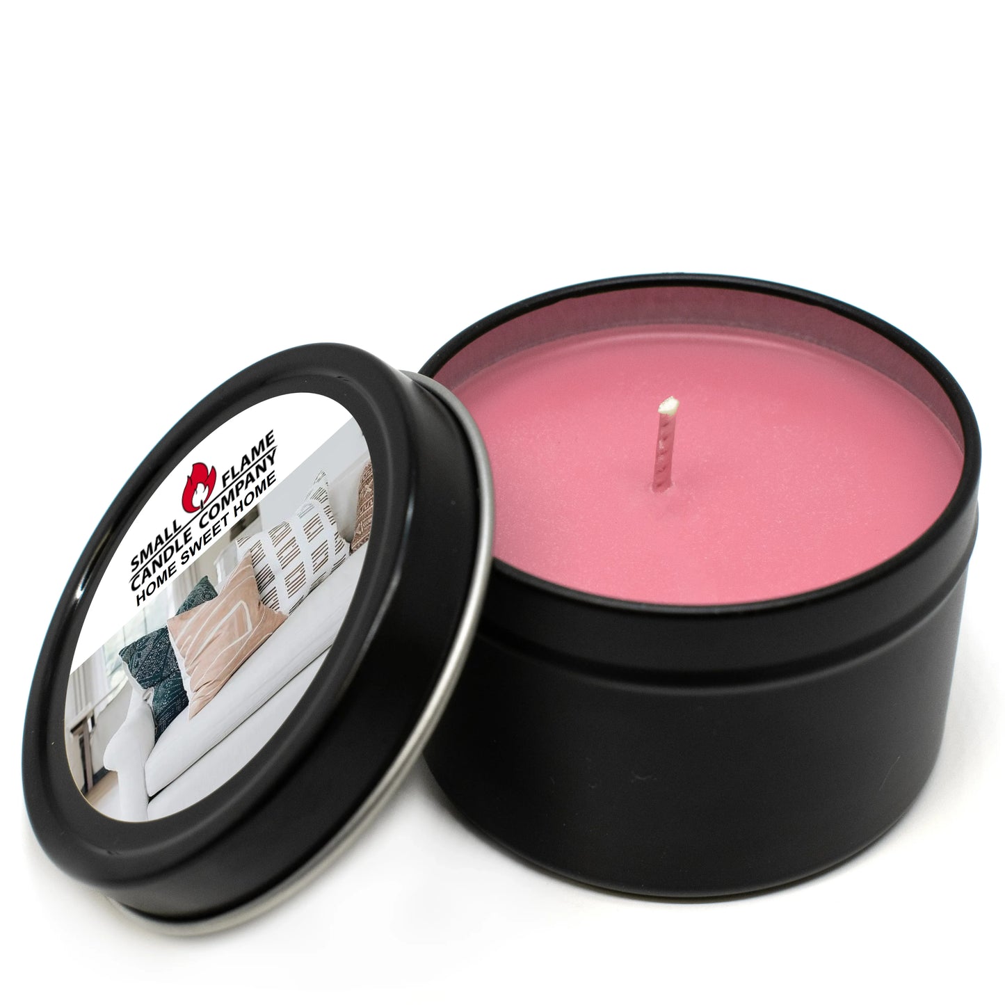 Pink coconut-soy wax candle in a black tin with open lid, labeled Home Sweet Home.