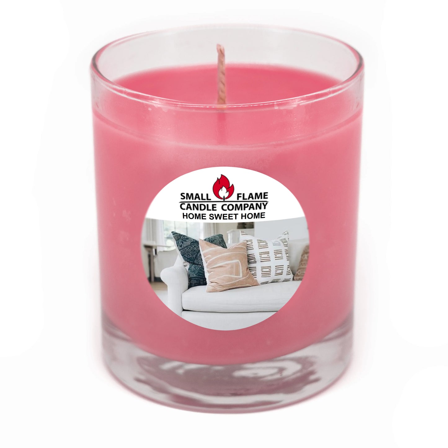 Pink coconut-soy candle in glass jar with 'Home Sweet Home' label and home décor.
