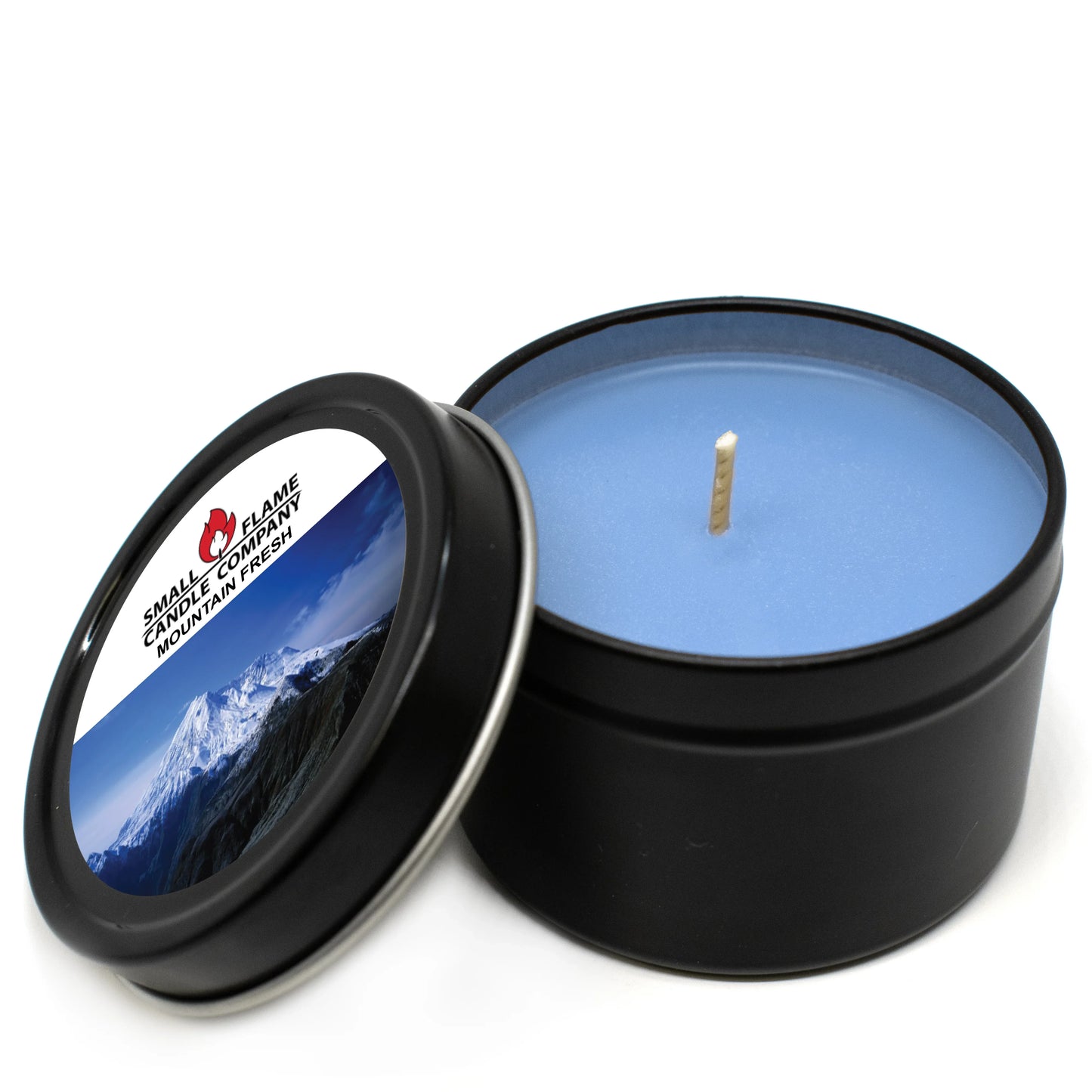 Blue coconut-soy candle in black tin with mountain fresh label and mountain image on lid