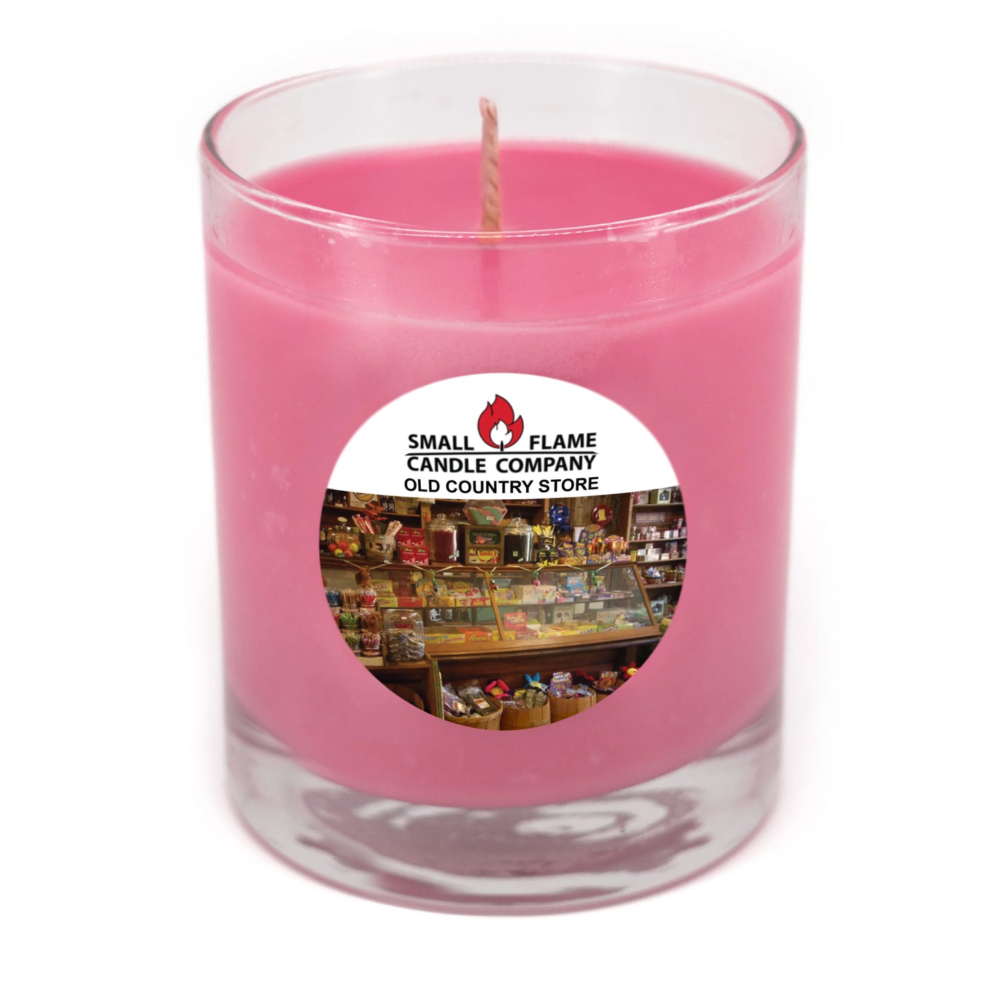 Pink coconut-soy candle in glass jar with Old Country Store label and wick visible