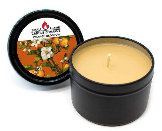 Orange Blossom coconut-soy candle in black tin with floral and fruit lid design