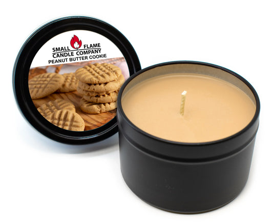 Peanut butter cookie scented coconut-soy candle in a black tin with cookies on lid label