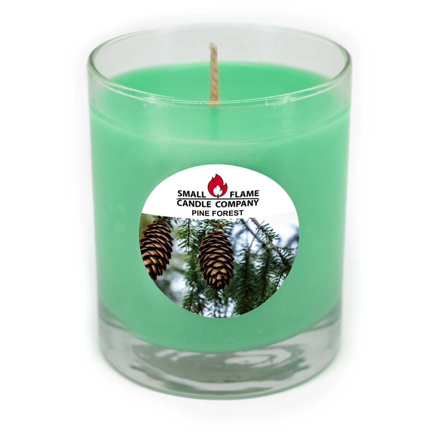 Green pine forest scented candle in clear glass jar with pine cone label