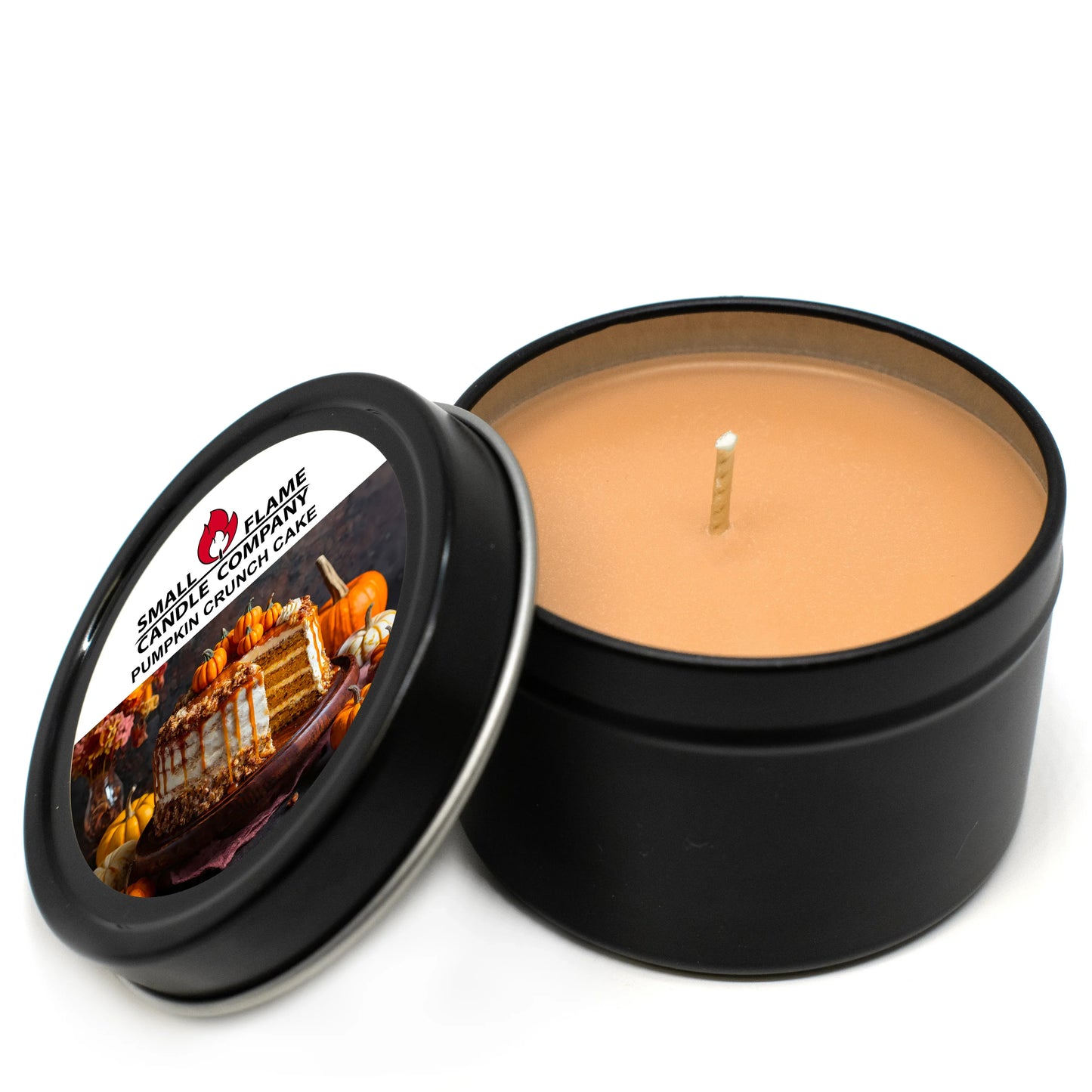 Pumpkin Crunch Cake coconut-soy candle in black tin with pumpkin-themed label, lid open